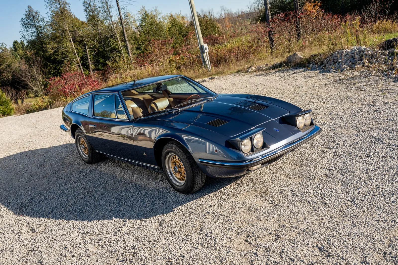 Maserati Indy on a gravel drive after detailing